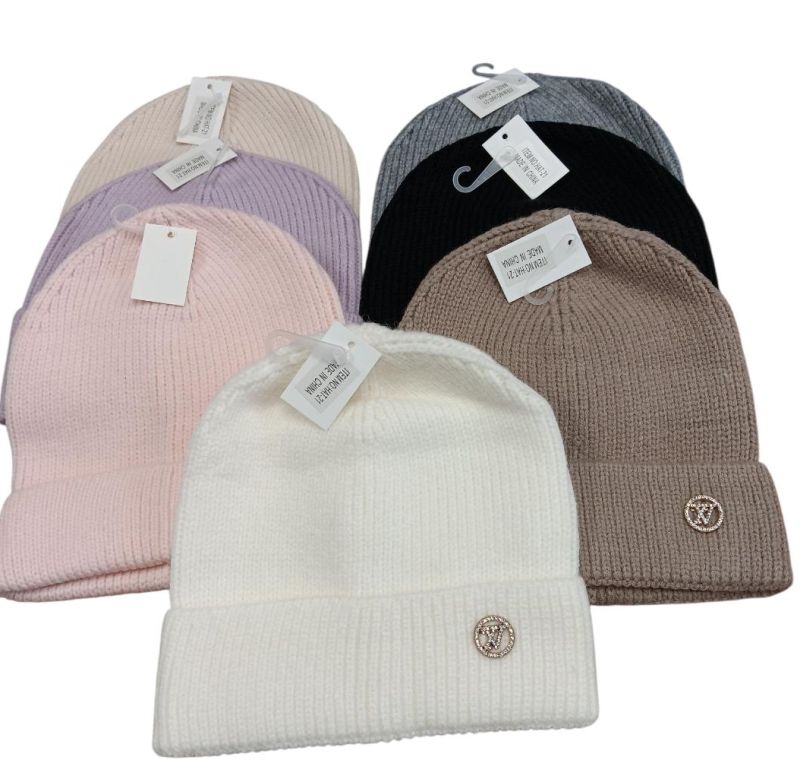 A set of soft knit beanies in pastel and neutral colors.